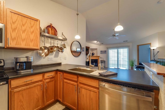 kitchen with sink, appliances with stainless steel finishes, kitchen peninsula, pendant lighting, and ceiling fan