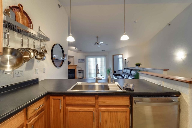 kitchen with vaulted ceiling, pendant lighting, sink, and stainless steel dishwasher