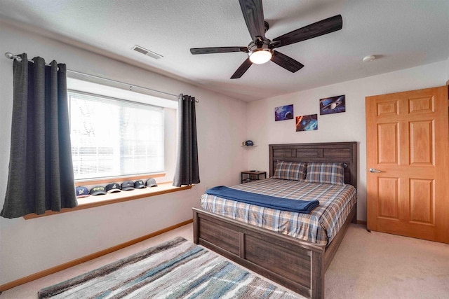 bedroom with light colored carpet and ceiling fan