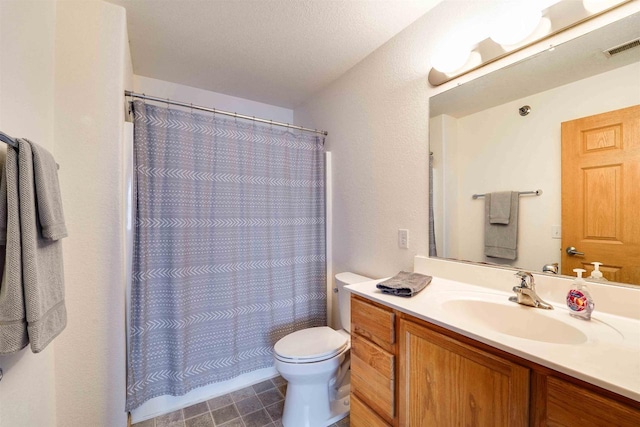 bathroom featuring vanity, curtained shower, a textured ceiling, and toilet