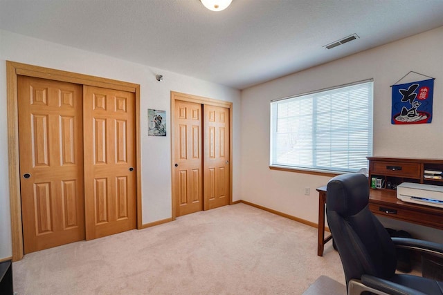 office area with light colored carpet and a textured ceiling