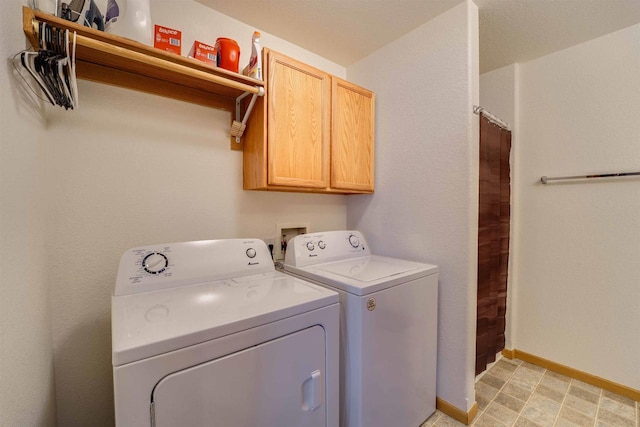 laundry area with cabinets and washer and clothes dryer