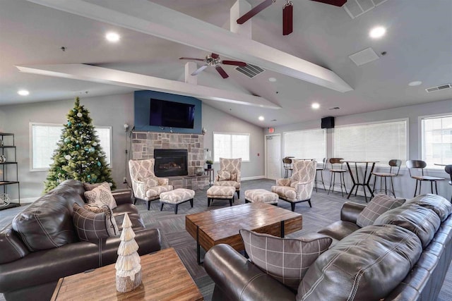 carpeted living room featuring ceiling fan, a fireplace, and vaulted ceiling with beams