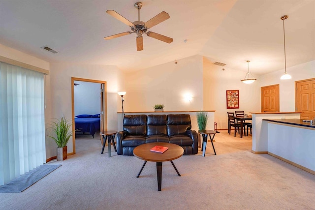 carpeted living room with ceiling fan and lofted ceiling