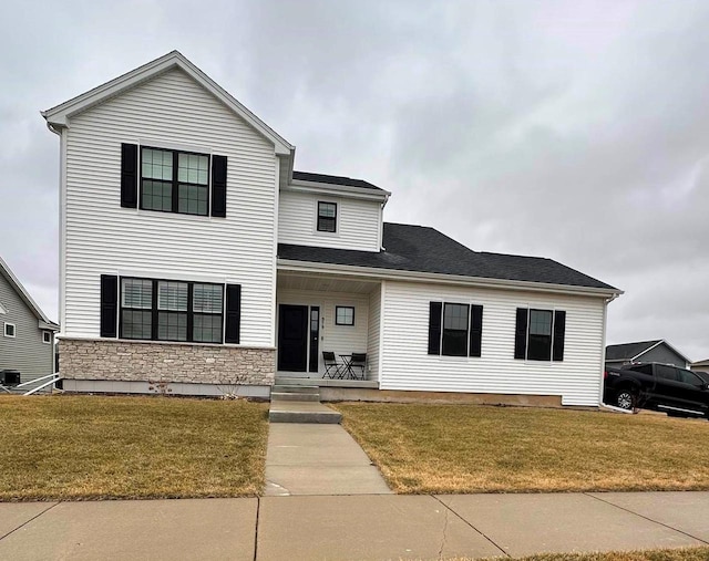 view of front of house with central AC, a front lawn, and a porch