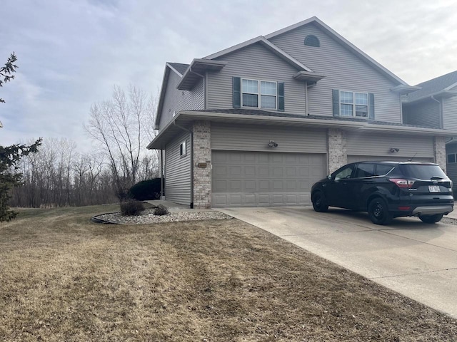 view of side of property with a garage and a lawn