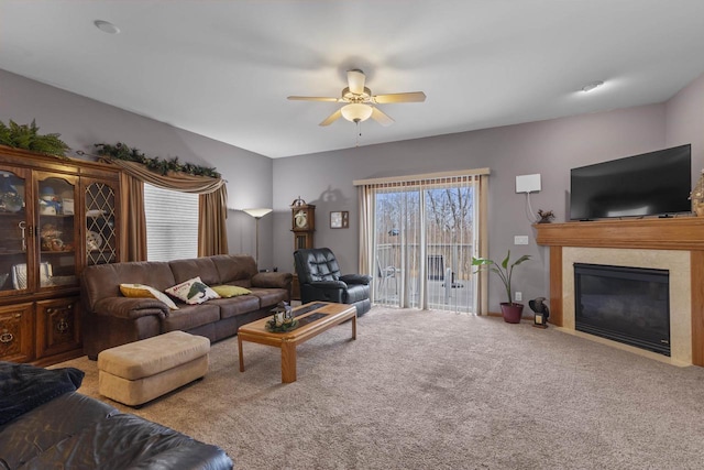 living room featuring carpet and ceiling fan