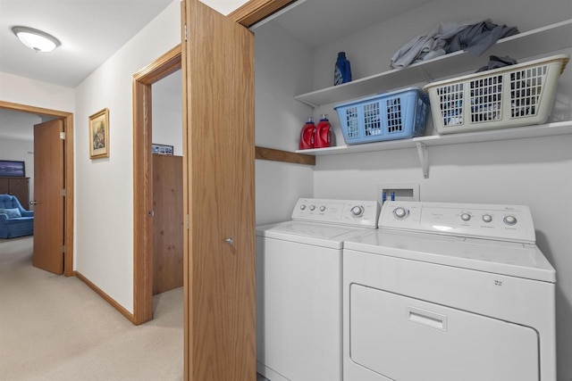 laundry room with light carpet and washer and dryer