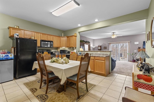 kitchen with ceiling fan, stainless steel appliances, kitchen peninsula, and light tile patterned floors