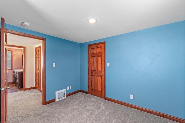 unfurnished bedroom with light colored carpet