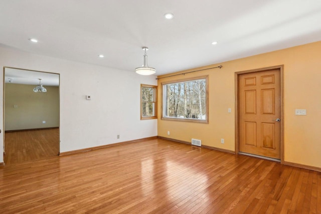 8209 N Port Washington Rd, Fox Point, WI 53217 - spare room featuring light wood-style floors, baseboards, visible vents, and recessed lighting