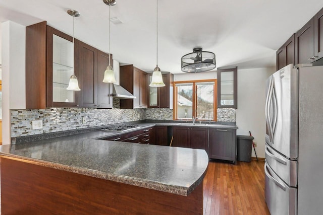 8209 N Port Washington Rd, Fox Point, WI 53217 - kitchen with stainless steel appliances, hanging light fixtures, a peninsula, and glass insert cabinets