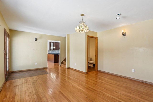 8209 N Port Washington Rd, Fox Point, WI 53217 - unfurnished room with light wood-type flooring, stairway, and baseboards
