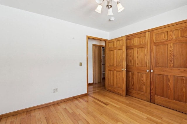8209 N Port Washington Rd, Fox Point, WI 53217 - unfurnished bedroom featuring ceiling fan, light wood finished floors, and baseboards