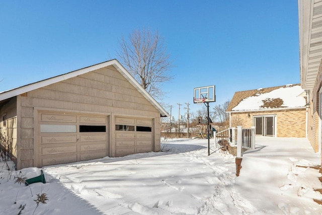 8209 N Port Washington Rd, Fox Point, WI 53217 - snow covered garage with a detached garage