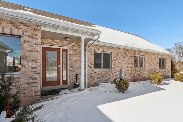 8209 N Port Washington Rd, Fox Point, WI 53217 - snow covered property entrance featuring brick siding