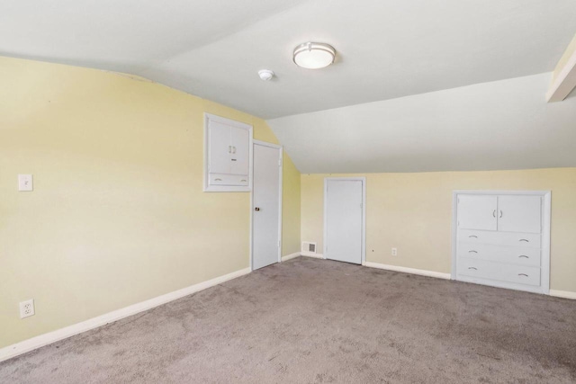 8209 N Port Washington Rd, Fox Point, WI 53217 - bonus room featuring carpet floors, visible vents, vaulted ceiling, and baseboards