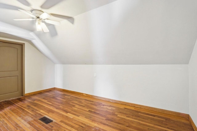 8209 N Port Washington Rd, Fox Point, WI 53217 - additional living space featuring lofted ceiling, visible vents, a ceiling fan, wood finished floors, and baseboards