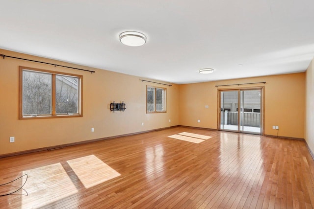 8209 N Port Washington Rd, Fox Point, WI 53217 - empty room with baseboards, a healthy amount of sunlight, and light wood-style floors
