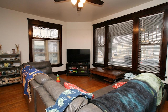 living room with dark hardwood / wood-style floors and ceiling fan