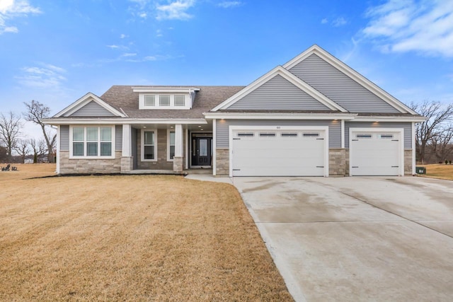 craftsman-style house featuring a garage and a front lawn