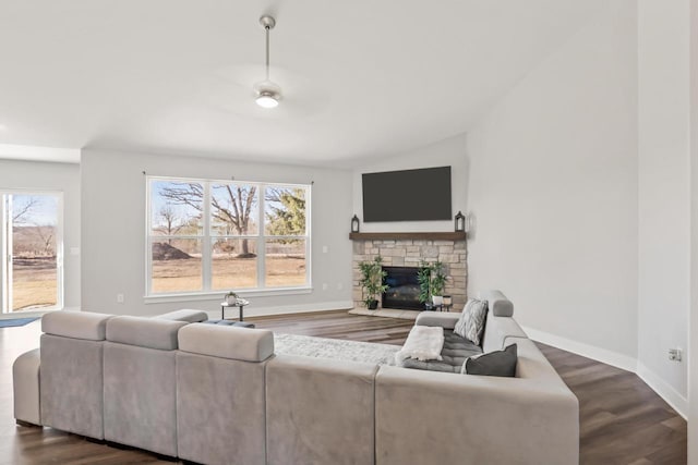 living room with lofted ceiling, a healthy amount of sunlight, a fireplace, and dark hardwood / wood-style floors