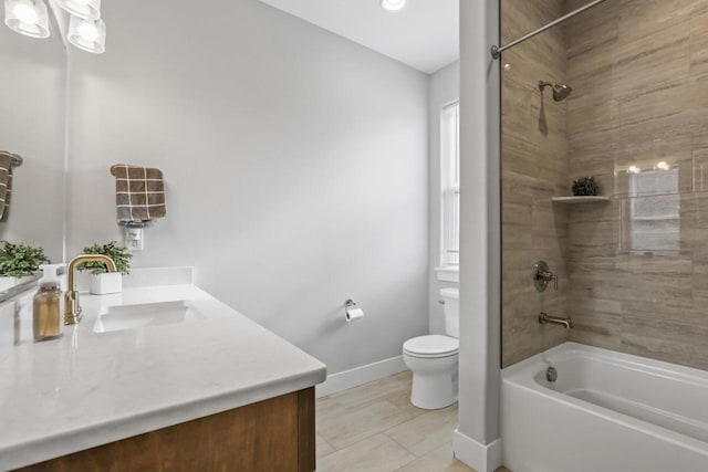 full bathroom featuring tiled shower / bath combo, vanity, and toilet