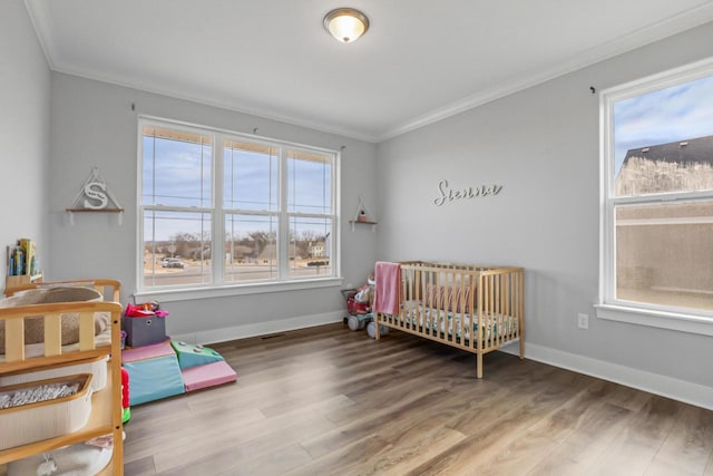 bedroom with hardwood / wood-style flooring and ornamental molding