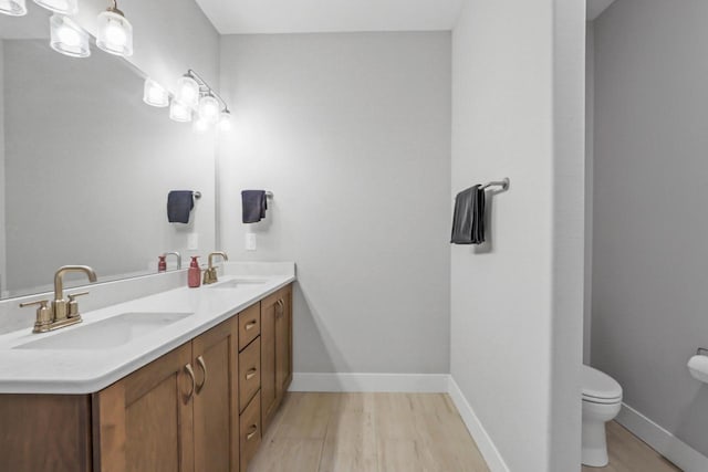 bathroom with vanity, hardwood / wood-style floors, and toilet