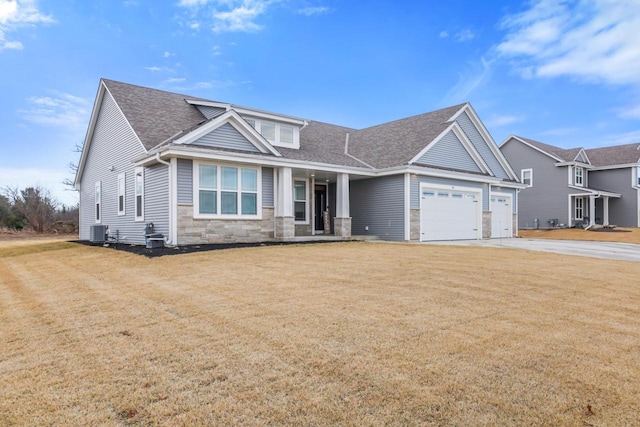 craftsman house featuring cooling unit, a garage, and a front lawn