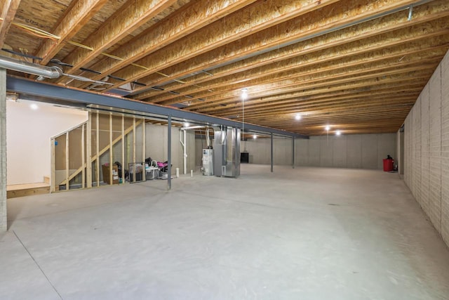 basement featuring gas water heater and heating unit