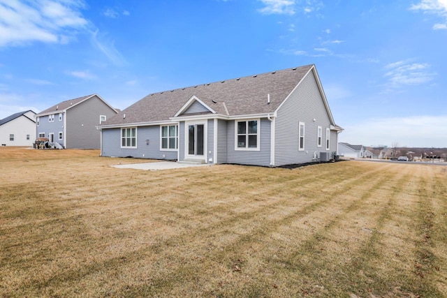 back of house with a patio, a yard, and central air condition unit