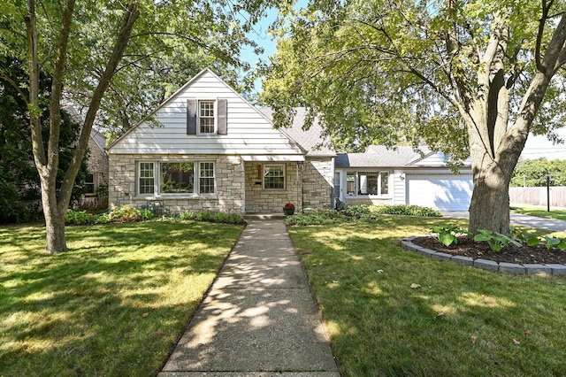 view of front of home with a garage and a front lawn