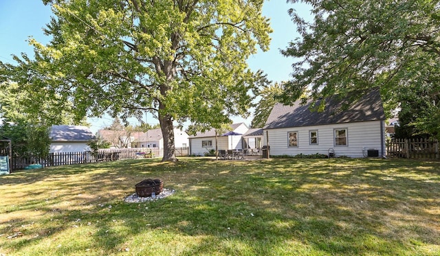 view of yard featuring a fire pit and central air condition unit