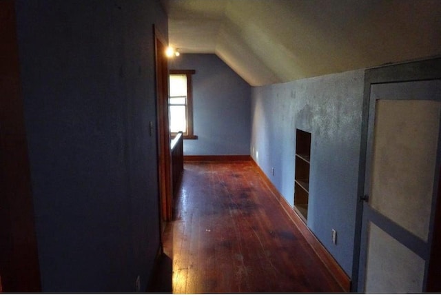 bonus room with vaulted ceiling and dark hardwood / wood-style flooring