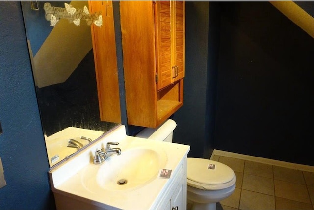 bathroom featuring vanity, tile patterned floors, and toilet