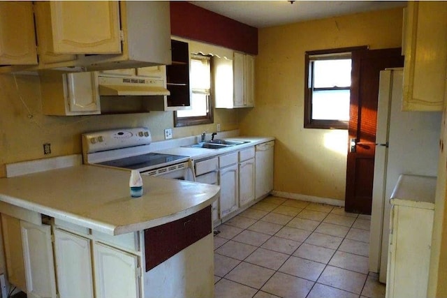 kitchen with sink, white appliances, kitchen peninsula, and light tile patterned flooring