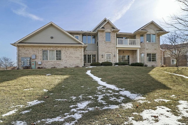 view of front of property with a lawn and a balcony