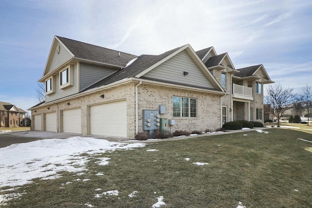 view of front of home with a garage and a yard