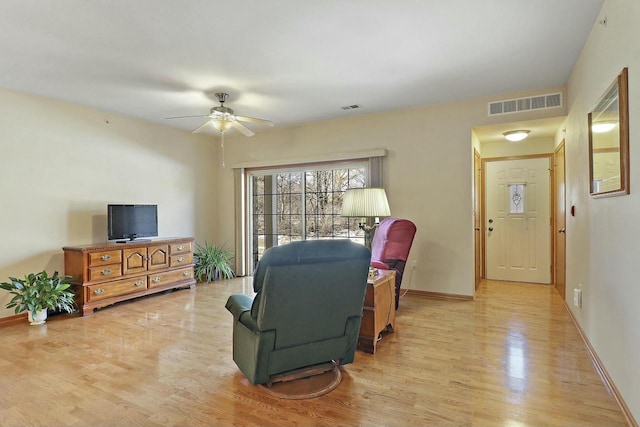 living room featuring ceiling fan and light wood-type flooring