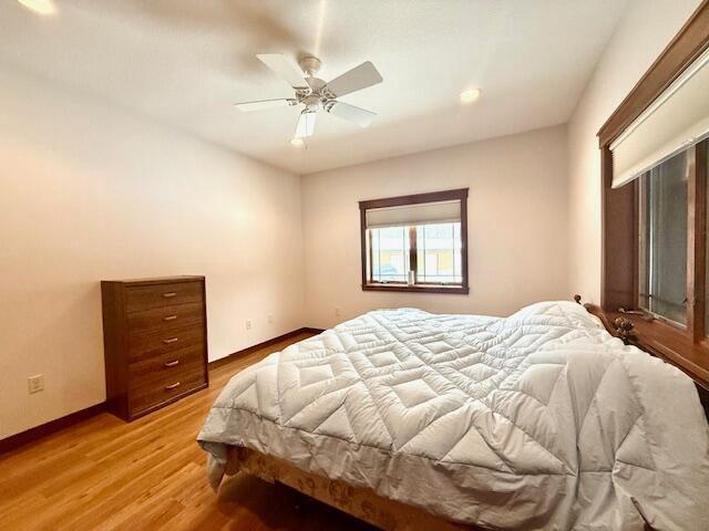 bedroom featuring light hardwood / wood-style floors and ceiling fan