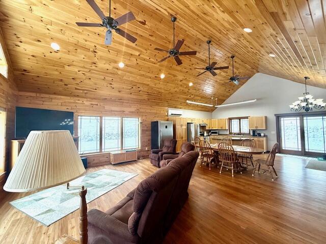 living room with high vaulted ceiling, a chandelier, wood ceiling, and light hardwood / wood-style floors