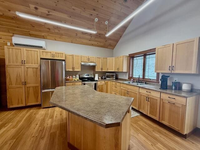 kitchen featuring an AC wall unit, sink, a center island, light hardwood / wood-style floors, and stainless steel appliances