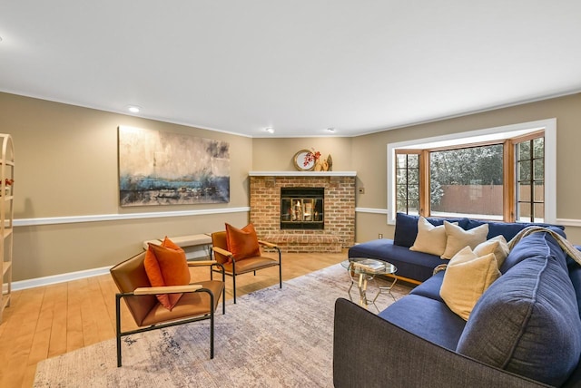 living room with hardwood / wood-style flooring and a brick fireplace