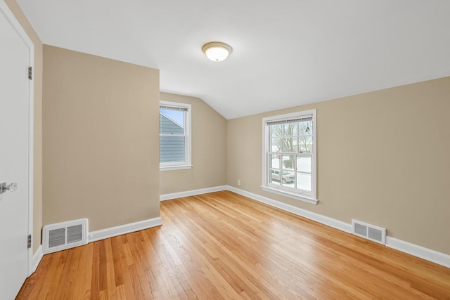 bonus room with hardwood / wood-style flooring, a healthy amount of sunlight, and vaulted ceiling