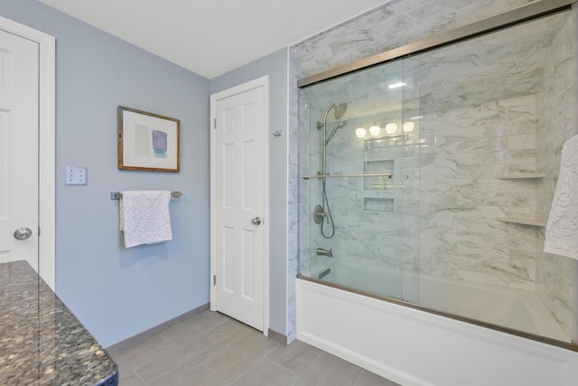 bathroom with combined bath / shower with glass door