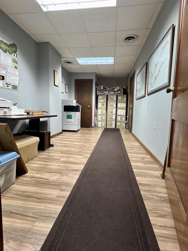 202 N Wisconsin Ave, Muscoda, WI 53573 - corridor with a paneled ceiling and light wood-type flooring