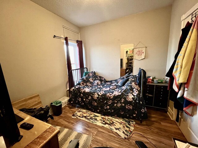 202 N Wisconsin Ave, Muscoda, WI 53573 - bedroom with dark wood-type flooring and a textured ceiling