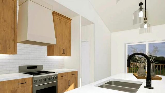 kitchen featuring pendant lighting, sink, backsplash, stainless steel range with gas stovetop, and custom exhaust hood