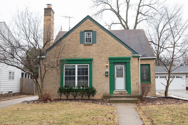 view of front of home with a garage and a front lawn